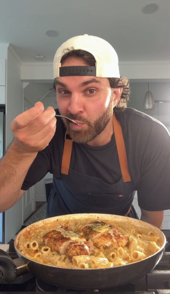 Ben eating creamy chicken pasta
